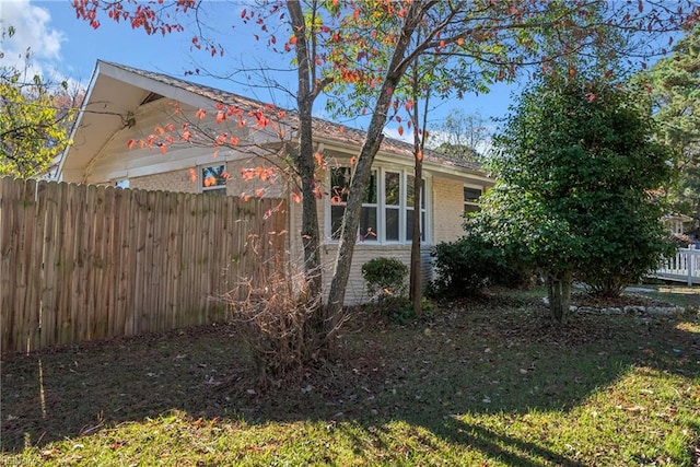 view of side of home featuring a lawn