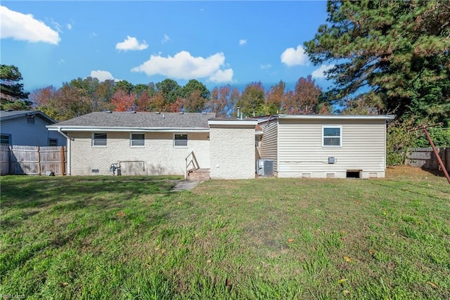 back of house with a lawn and central AC unit