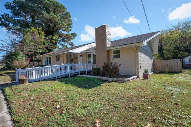 rear view of property featuring a lawn