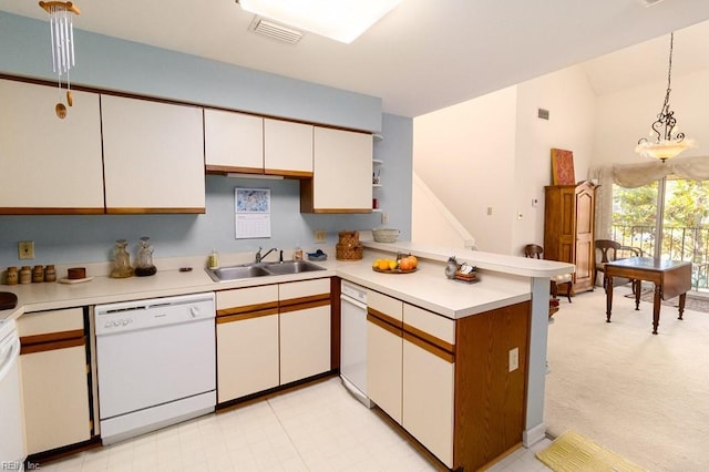 kitchen featuring dishwasher, white cabinets, sink, hanging light fixtures, and kitchen peninsula