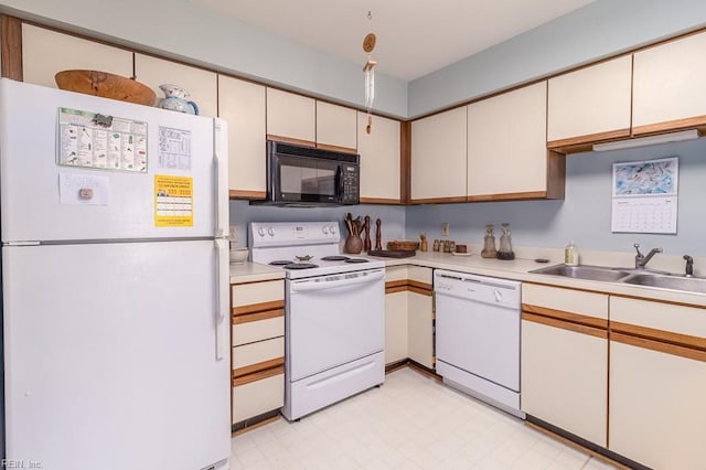 kitchen with white cabinets, white appliances, and sink