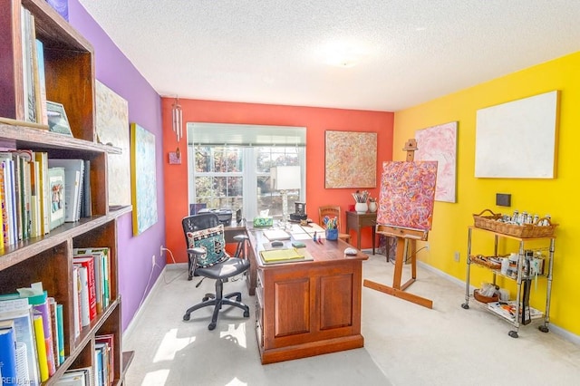 office with light carpet and a textured ceiling