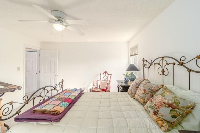 bedroom with a textured ceiling and ceiling fan