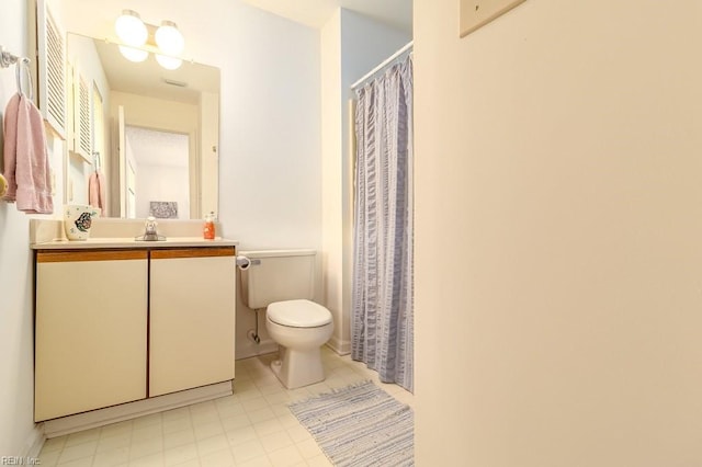 bathroom featuring vanity, toilet, and curtained shower