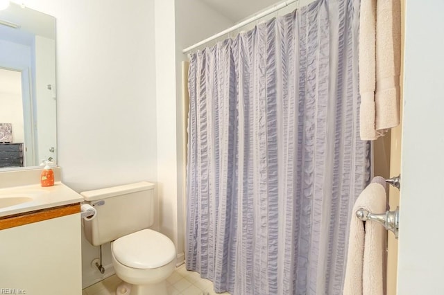 bathroom featuring tile patterned flooring, vanity, and toilet