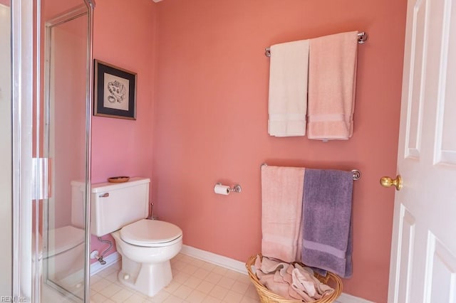 bathroom with toilet and a shower with door