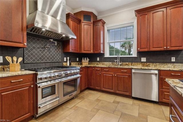 kitchen featuring backsplash, wall chimney exhaust hood, sink, and stainless steel appliances