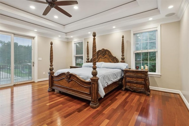 bedroom with access to exterior, ceiling fan, crown molding, hardwood / wood-style floors, and a tray ceiling