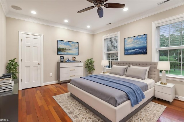 bedroom featuring hardwood / wood-style flooring, ceiling fan, and ornamental molding