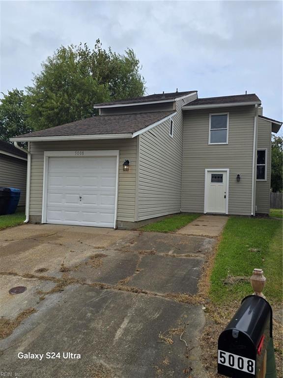 exterior space featuring a garage and a front yard