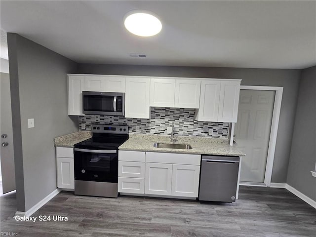 kitchen featuring white cabinets, sink, and appliances with stainless steel finishes