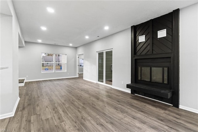 unfurnished living room with hardwood / wood-style flooring and a fireplace