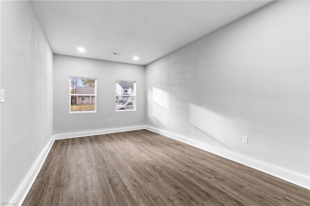 spare room with dark hardwood / wood-style floors