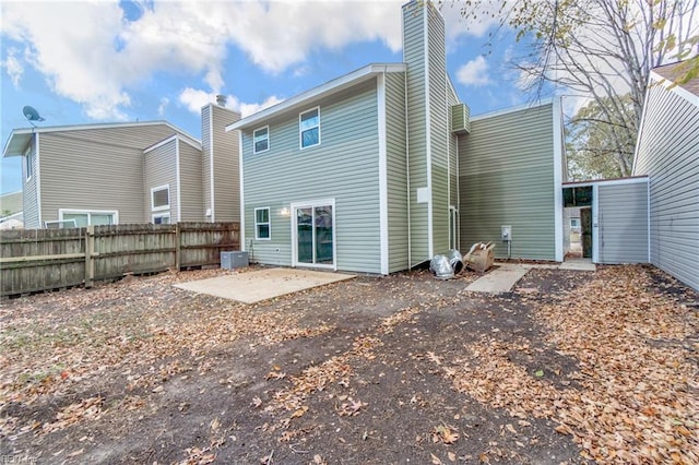 rear view of house with cooling unit and a patio