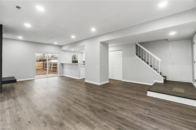 unfurnished living room featuring dark hardwood / wood-style floors