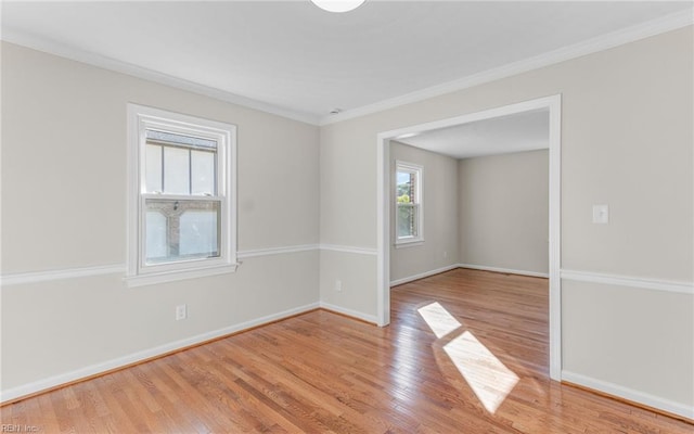 spare room with crown molding and light hardwood / wood-style floors