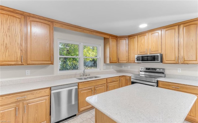 kitchen featuring sink, light tile patterned floors, and appliances with stainless steel finishes