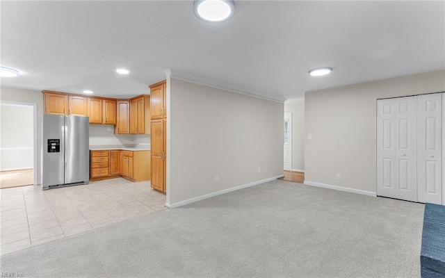 kitchen with stainless steel fridge with ice dispenser and light carpet