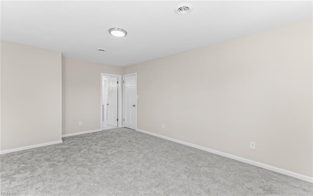 spare room featuring light colored carpet