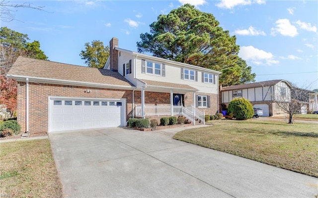 view of property with a garage, covered porch, and a front yard