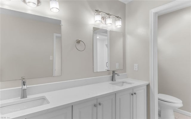 bathroom featuring tile patterned floors, vanity, and toilet