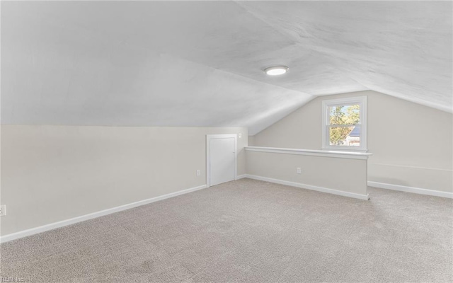 additional living space featuring carpet floors and lofted ceiling