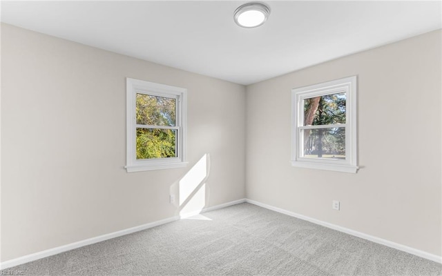 carpeted empty room featuring a healthy amount of sunlight