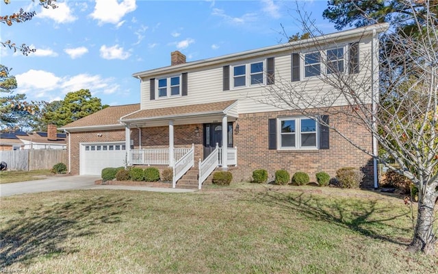 view of property with a front lawn, covered porch, and a garage