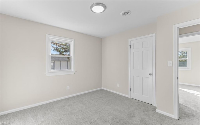 unfurnished bedroom featuring light colored carpet