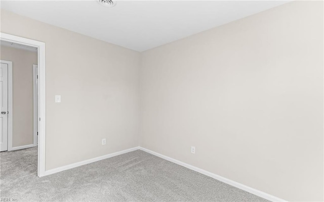 unfurnished room featuring light colored carpet