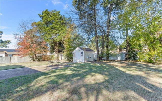 view of yard featuring a storage unit and a patio area