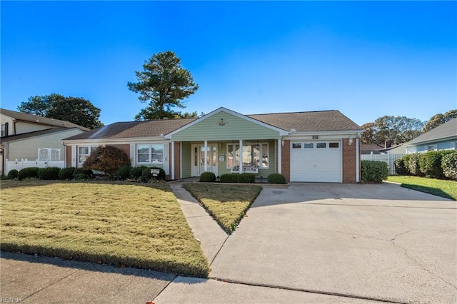 view of front of property with covered porch, a garage, and a front yard