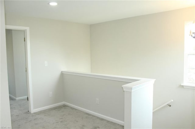 hallway featuring light carpet