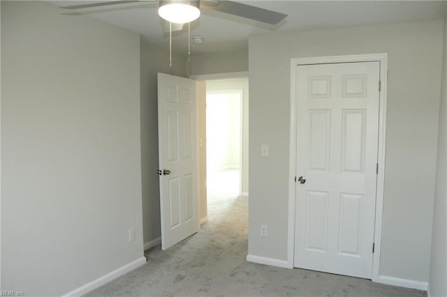 unfurnished bedroom featuring ceiling fan and light carpet