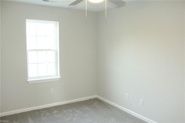 carpeted spare room with ceiling fan