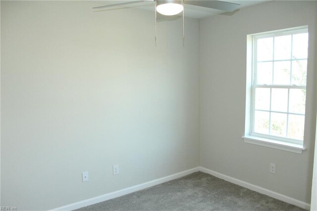 carpeted empty room featuring ceiling fan