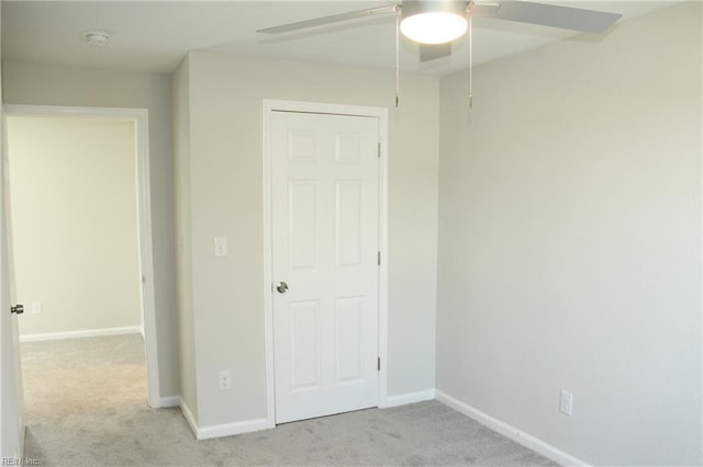 unfurnished bedroom featuring ceiling fan and light colored carpet