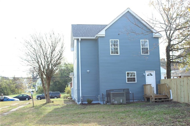 rear view of house featuring a lawn