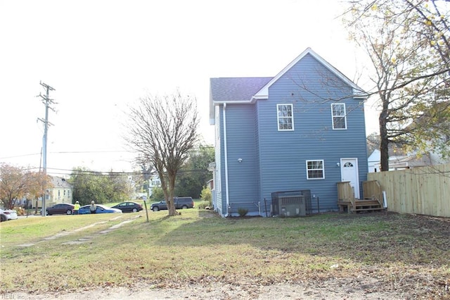 rear view of house featuring a yard