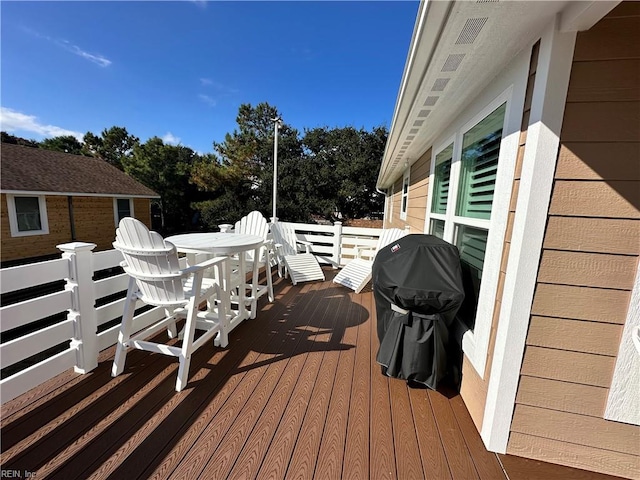 wooden terrace with area for grilling