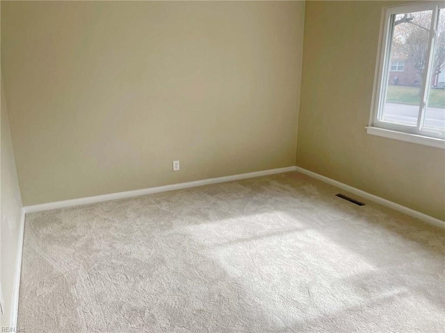 unfurnished room featuring light colored carpet