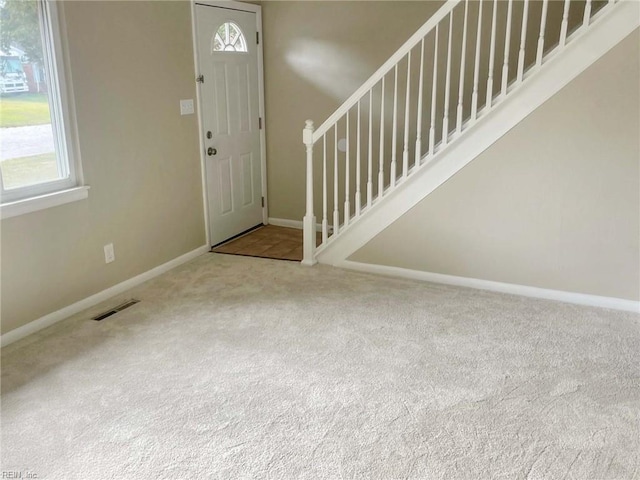 entrance foyer featuring carpet