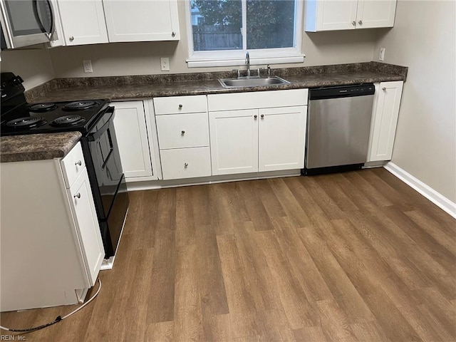 kitchen featuring white cabinets, wood-type flooring, stainless steel appliances, and sink