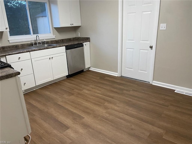 kitchen featuring stainless steel dishwasher, white cabinetry, sink, and dark wood-type flooring