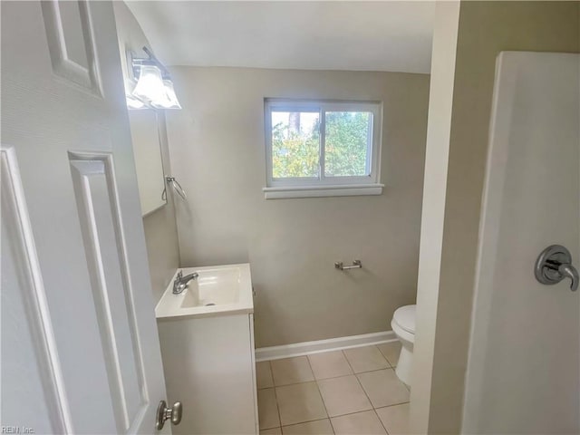 bathroom featuring tile patterned floors, vanity, and toilet