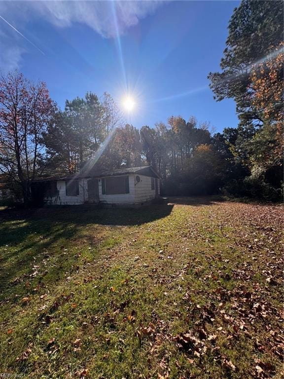 view of side of home featuring a lawn