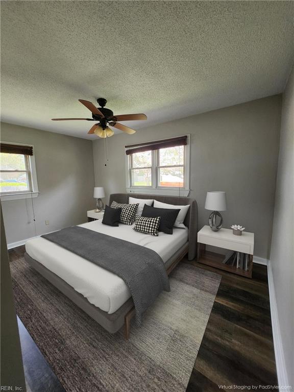 bedroom featuring a textured ceiling, ceiling fan, and dark wood-type flooring