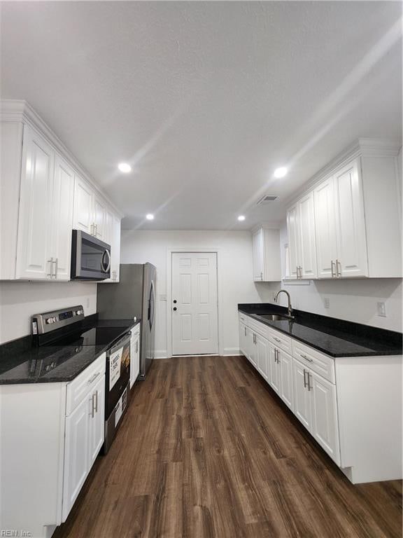 kitchen featuring white cabinets, dark hardwood / wood-style flooring, stainless steel appliances, and sink