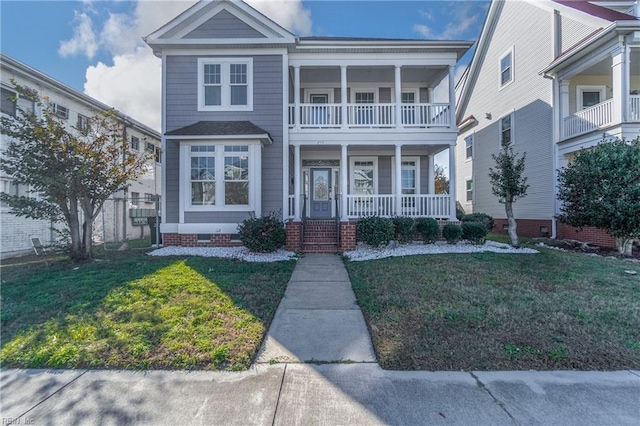 view of front of property with a balcony and a front lawn