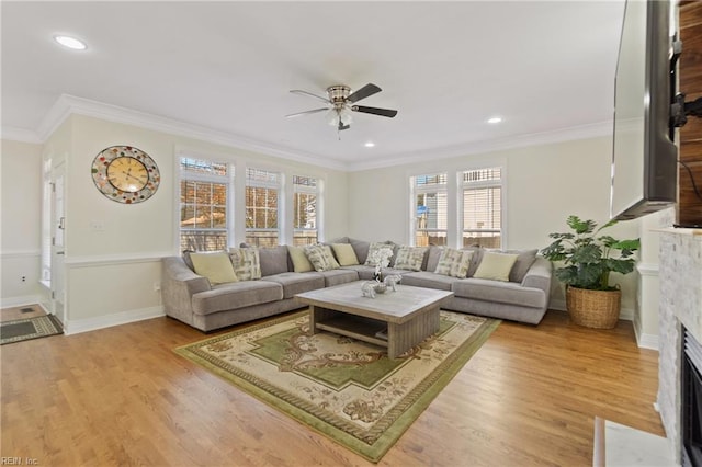 living room featuring hardwood / wood-style floors, ceiling fan, and ornamental molding